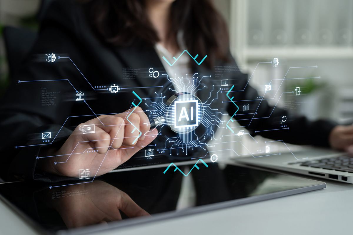 A person using a laptop with an AI network displayed in front of them
